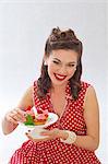 A retro-style girl holding a plate of strawberry muffins