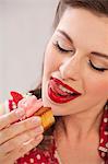 A girl eating a strawberry muffin