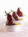 Poached Pears with Candies Orange Peels in White Bowls