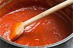 Pot of Simple Tomato Sauce; Wooden Spoon