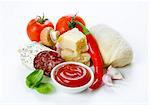 Pizza ingredients: tomatoes, a ball of dough, parmesan, Italian salami, garlic, ketchup, mushrooms