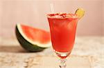 Watermelon Refresher in a Glass with Straw; Piece of Watermelon