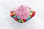 Strawberry yogurt ice cream with colourful chocolate beans