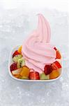 Strawberry yogurt ice cream garnished with mixed fruit