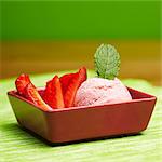 Strawberry ice cream with fresh strawberries and mint