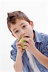 A little boy eating an apple