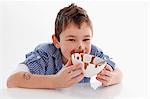 Small boy eating chocolate pudding