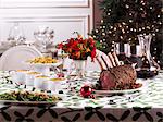 Christmas table with roast prime rib and side dishes