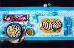 Maroccan roast turkey in slices on couscous with cauliflower and salad (viewed from above)