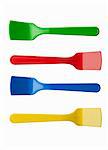 Four brightly colored ice cream spoons