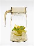 Glass carafe with lemons, mint and ice cubes