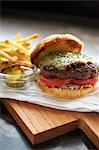 Cheeseburger mit Tomaten; Gurken und Pommes frites