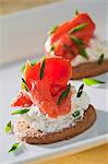 Smoked salmon with cream cheese and chives on a cracker
