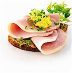 Rye bread with ham, scrambled egg and water cress