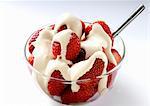 Strawberries in a glass bowl with cream