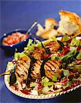 Grilled scallop kebabs on a bed of salad