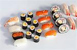 Various type of sushi on a white surface