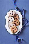 Linzer Augen (nutty shortcrust jam sandwich biscuits with holes on top) on a serving plate