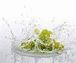 Green grapes falling into water