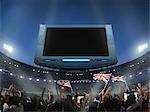 Spectateurs agitant le drapeau britannique dans le stade, écran