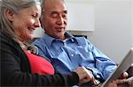 Older couple using tablet computer