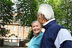 Older couple walking in park