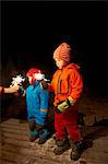 Boys playing with sparkler outdoors