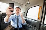 Businessman cheering on cell phone