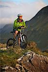 Mountain biker standing on hilltop