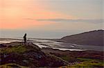 Mountain biker standing on hilltop