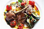 Plate of lamb cutlets with tomatoes