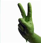 Green painted hand making peace sign