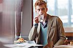 Man sitting in a restaurant and drinking water