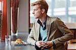 Man sitting in a restaurant taking lunch