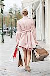 Rear view of a woman carrying shopping bags