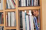 Woman choosing books from a bookshelf