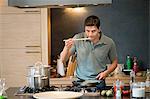 Man tasting food in the kitchen