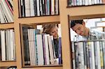 Couple choosing books from a bookshelf