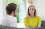 Couple sitting together, woman ignoring boyfriend