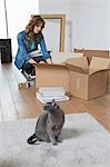 Woman putting books in a cardboard box