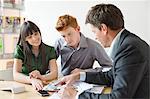 Real estate agent discussing property documents to his clients