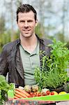 Man holding a tray of raw vegetables