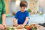 Boy cutting vegetables in the kitchen