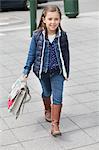 Portrait of a schoolgirl carrying schoolbag