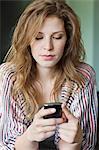 Close-up of a beautiful woman text messaging on a mobile phone