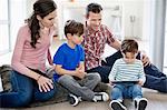 Parents looking at their children using a digital tablet