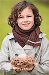 Boy holding a bird's nest