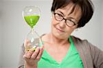 Woman looking at an hourglass