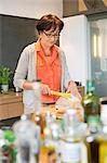 Woman cutting bread in the kitchen