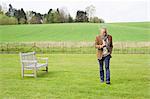 Man using a mobile phone in a field